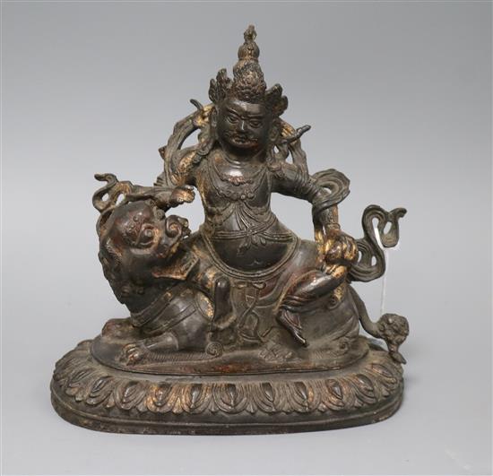 A Chinese bronze group of Vaisravana riding a snow lion height 18.5cm